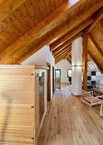 a large room with wooden ceilings and a wooden floor at LAntica Torre in Pontebba