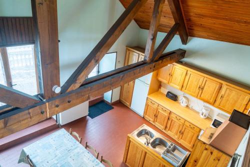 an overhead view of a kitchen with wooden cabinets at Gites de france 6 personnes a pierrefiche in Pierrefiche