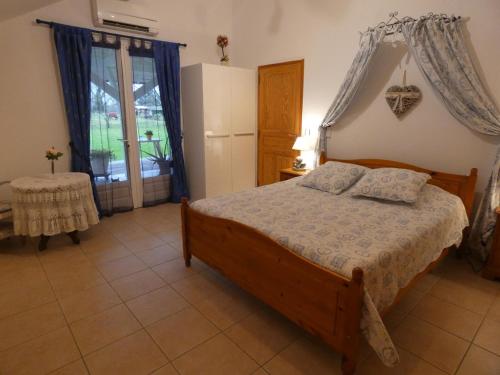 1 dormitorio con 1 cama, nevera y mesa en Louisiane, en Onard