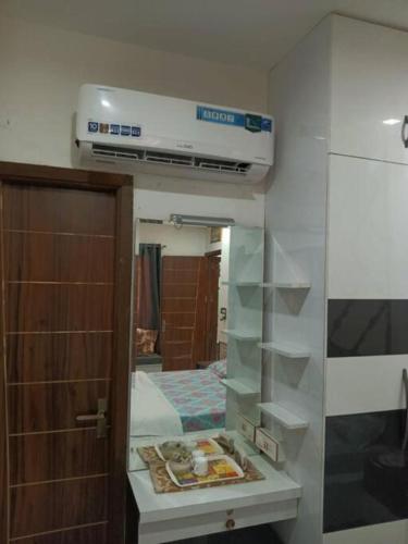 a room with a kitchen with a stove and a bed at The Great Escape - Rustic Countryside Stay in Amritsar