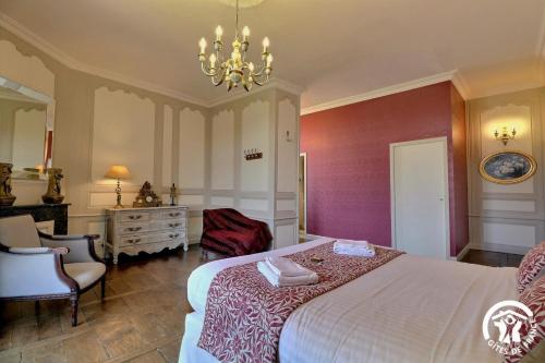 a bedroom with a bed and a desk and a chair at Chateau de la giraudais in Mézières-sur-Couesnon