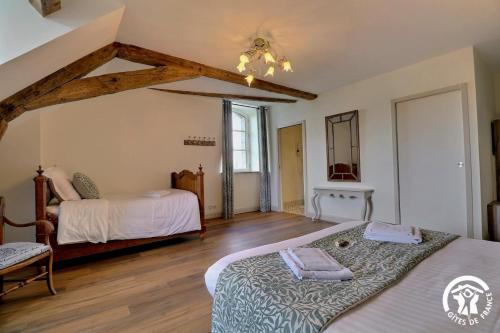 a bedroom with two beds in a room at Chateau de la giraudais in Mézières-sur-Couesnon