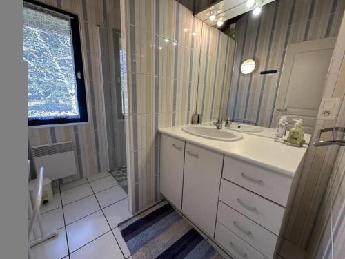 a white bathroom with a sink and a shower at Peyrot in Onesse-et-Laharie
