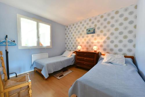 a bedroom with two beds and a window at Chez forcade in Lanne en Barétous