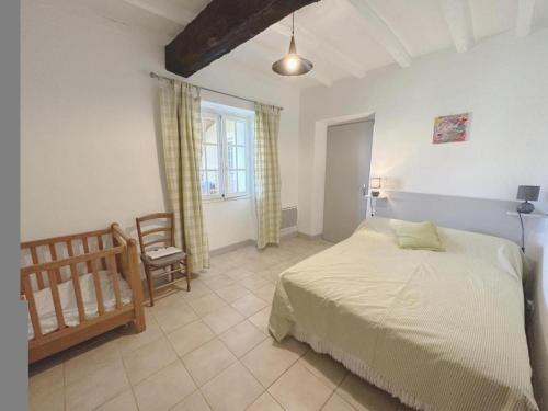 a bedroom with a bed and a chair in it at Gîte jean in Horsarrieu