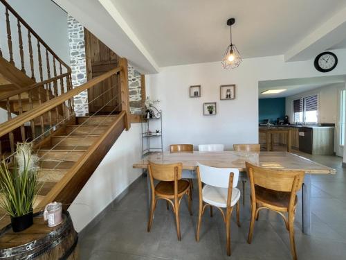 a kitchen and dining room with a table and chairs at Larrouy in Asson