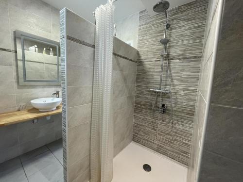 a bathroom with a shower and a sink at Larrouy in Asson