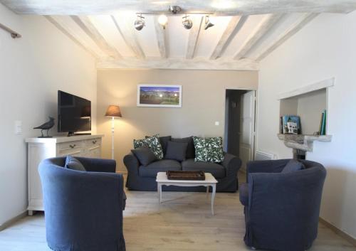 a living room with a couch and two chairs at Labourdette in Lasseube