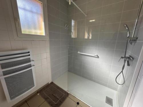 a bathroom with a shower with a glass door at Gabardan in Mugron