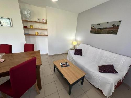 a living room with a white couch and a table at Gabardan in Mugron