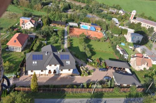 an aerial view of a house with a yard at Penzion Pod Hradem in Potštejn