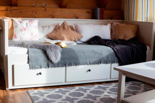 a white bed with pillows and blankets on it at Haus Rose in Allensbach