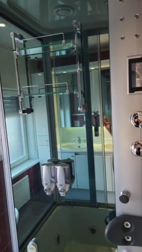 a bathroom with a mirror and a sink at Cristina Residence - App 1 in Staden