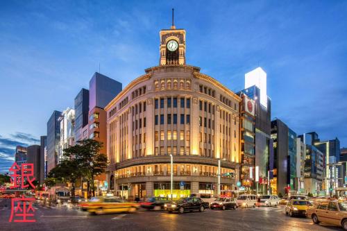 a large building with a clock tower on top of it at Relax House in Tokyo
