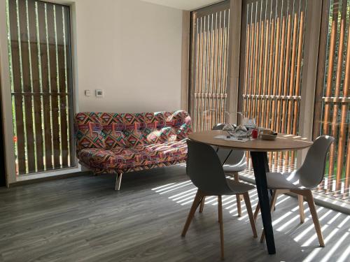 a living room with a table and a couch at Penzion Na Habeši in Kašperské Hory