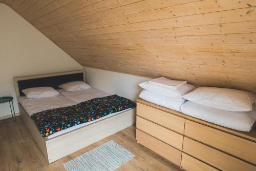 a small bedroom with a bed and two pillows at Domki Borys in Jastrzębia Góra