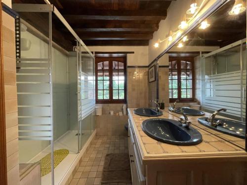 a bathroom with three sinks and a shower at Aguerre in Lichos