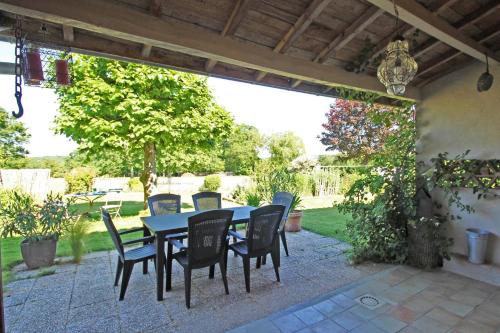 a table and chairs sitting on a patio at Chez minetou in Saint-Gence