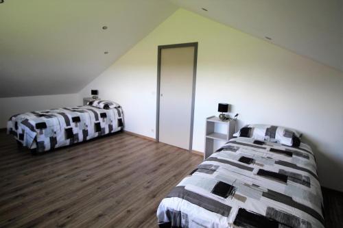 a bedroom with two beds in a attic at Bois de l'age in Saint-Auvent