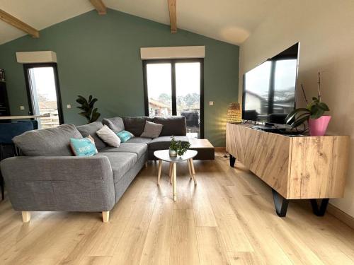 a living room with a couch and a table at Le cap in Lit-et-Mixe