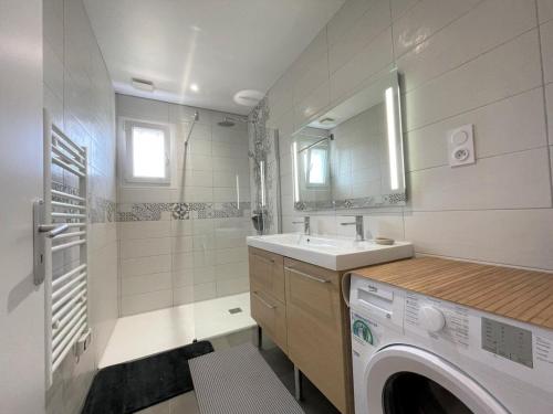 a bathroom with a washing machine and a sink at Gure doya in Ibarrolle