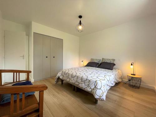 a bedroom with a large bed and two lamps at Gure doya in Ibarrolle