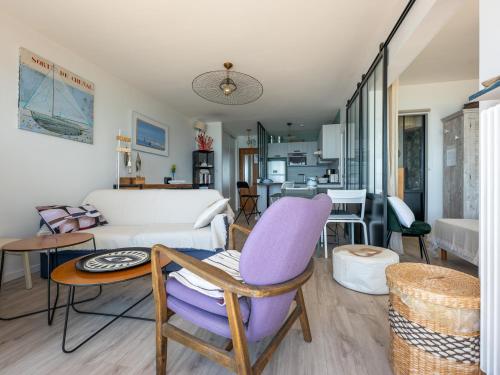 - un salon avec un fauteuil violet et un canapé dans l'établissement Appartement 3* face à la plage avec balcon et cuisine équipée - FR-1-197-587, à Les Sables-dʼOlonne