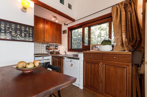 a kitchen with wooden cabinets and a table and a window at Molarotto in Porto Taverna