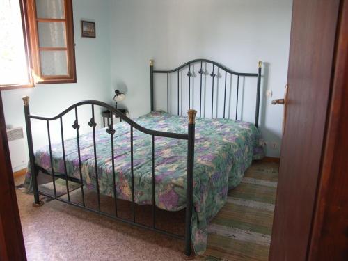a bedroom with a bed with a floral bedspread at Le pin franc in Azur