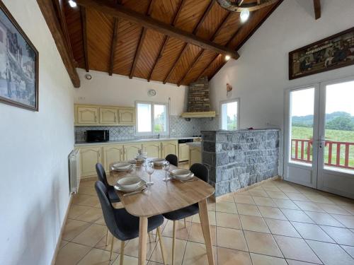 a dining room with a wooden table and chairs at Bixta eder in Hélette