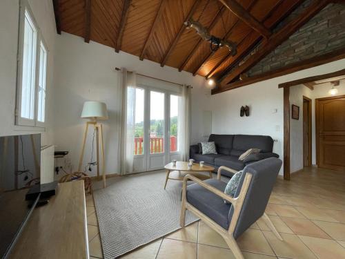 a living room with a couch and a table at Bixta eder in Hélette