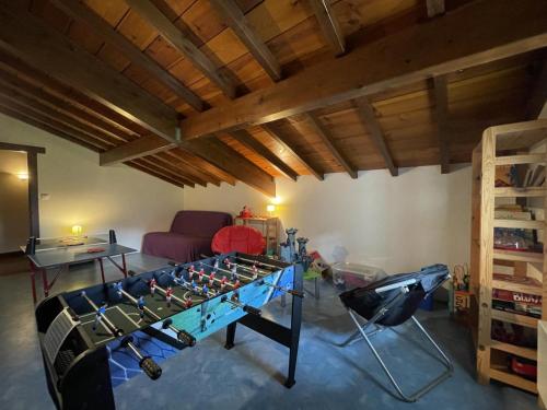a living room with a foosball table in the middle at Lexorua in Ibarrolle
