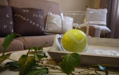 a glass vase sitting on a table with a lime at Au clos champenois in Lusigny-sur-Barse