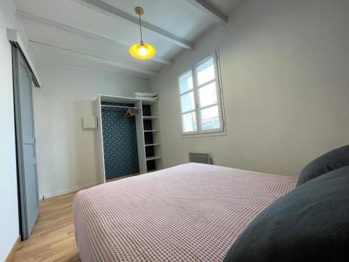 a bedroom with a bed and a window at Ekialde in Ainhoa