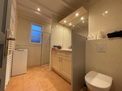 a bathroom with a toilet and a sink at Ekialde in Ainhoa