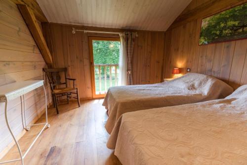 a bedroom with two beds and a window in it at Vieux chene in Sabres