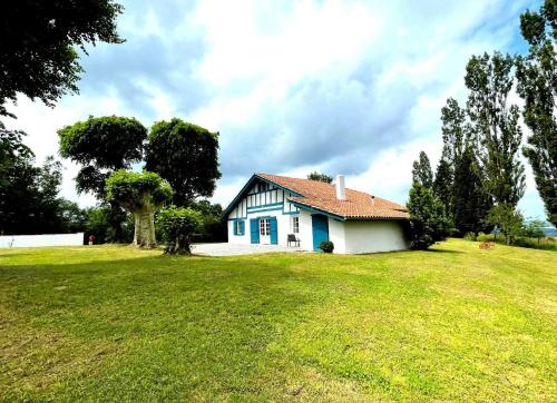 a small white house on a grassy field at Trebuc in Labastide-Clairence