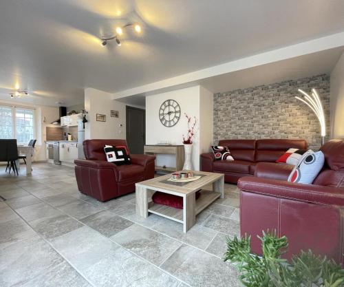 a living room with two red couches and a table at Uharte beherea in Souraïde