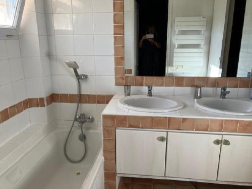 La salle de bains est pourvue de 2 lavabos, d'une douche et d'une baignoire. dans l'établissement Gite 2 personnes les manoullieres, à Laouque