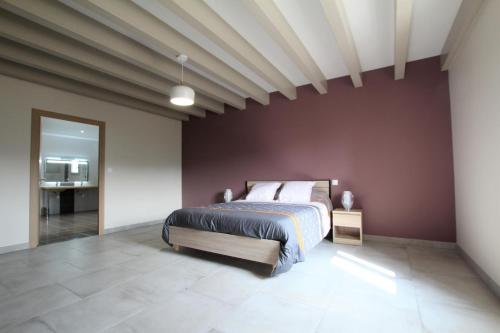 a bedroom with a king sized bed in a red wall at Bordazarria in Juxue