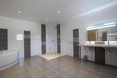 a bathroom with a tub and two sinks and a bath tub at Bordazarria in Juxue