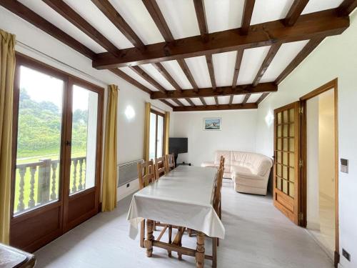 a dining room with a table and a couch at Iparla in Urrugne