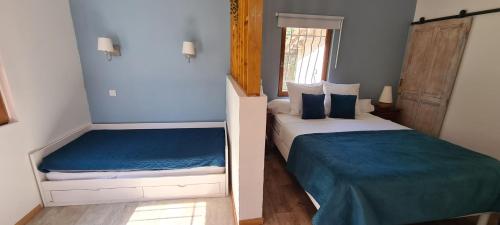 a small bedroom with two beds and a window at Le Mas des Cerisiers JACUZZI et SAUNA inclus pour tous les logements in Avignon