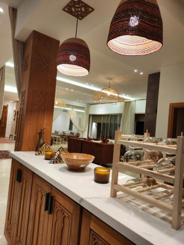 a kitchen with two pendant lights and a counter at Riad Tammam in Essaouira