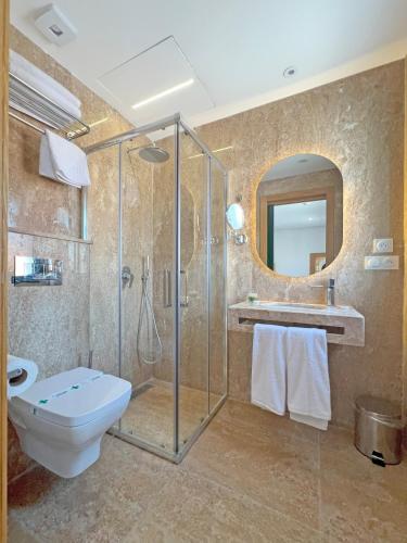 a bathroom with a shower and a toilet and a sink at Soho Boutique Tetuán in Tetouan