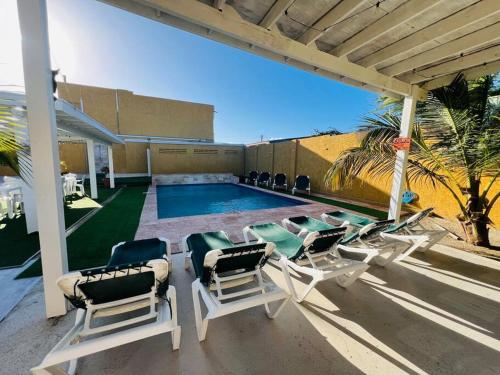 a group of lawn chairs and a swimming pool at The Gold Vacation Apartments in Santa Cruz