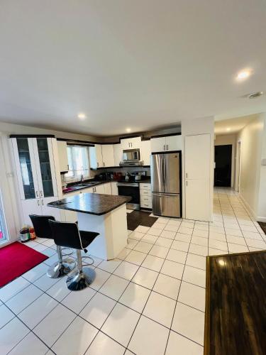 a large kitchen with a table and chairs in it at Motel LA RÉFÉRENCE in Trois-Rivières