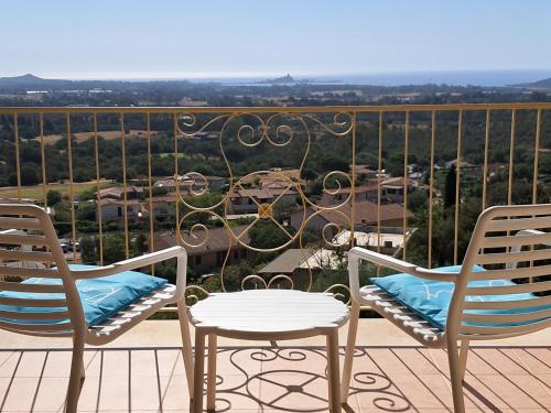 due sedie e un tavolo su un balcone con vista di Golf & Sea Residence Is Molas a Pula