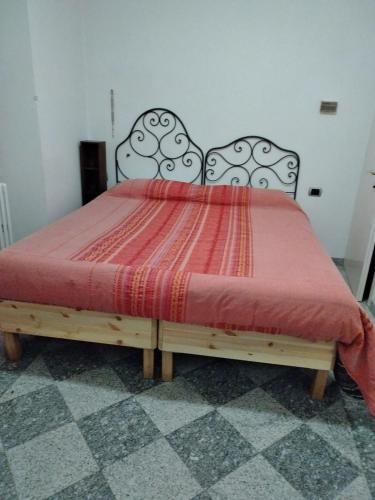 a bedroom with a bed with a red comforter at IL FAGGIO ROSSO in Missaglia