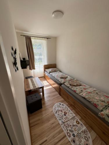 a room with two beds and a table at Apartmán v Jáchymově pro 4 osoby, free wifi in Jáchymov